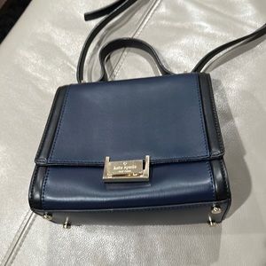 Kate spade cross body small bag in good condition - dent and marking on back